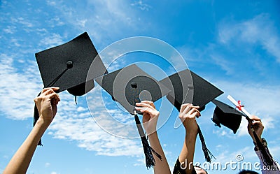 Holding graduation hats Stock Photo