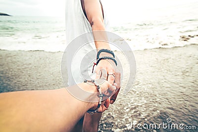 Holding hands on the beach Stock Photo