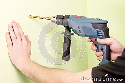 Holding in hands Electric drills Stock Photo