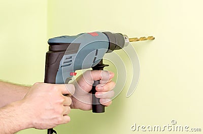 Holding in hands Electric drills Stock Photo