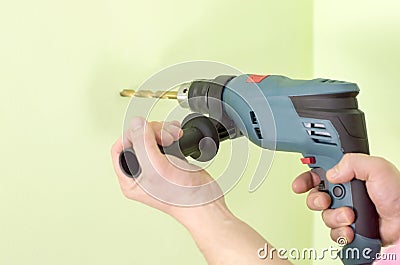 Holding in hands Electric drills Stock Photo