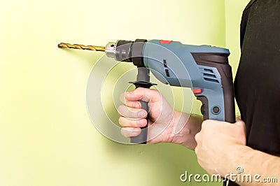 Holding in hands Electric drills Stock Photo