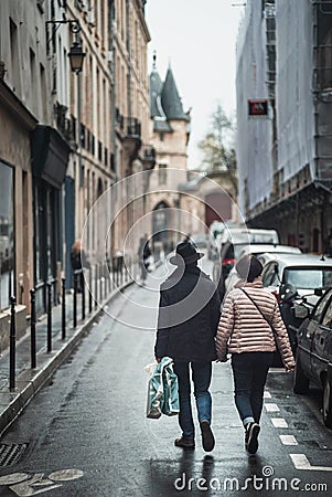 Holding hands in the Paris Rain Editorial Stock Photo