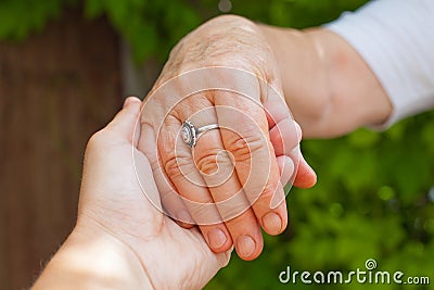 Holding hands, Parkinson disease Stock Photo