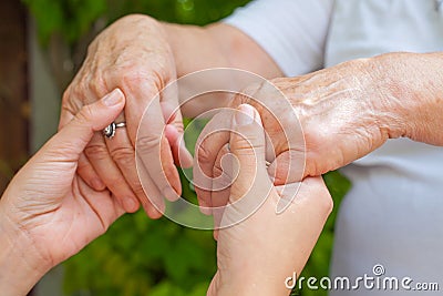 Holding hands, Parkinson disease Stock Photo