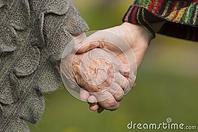 Holding hands together - old and young. Love. Stock Photo