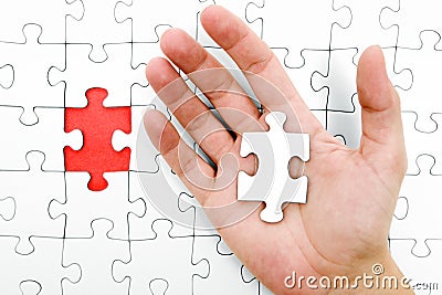 Holding a Jigsaw Piece Stock Photo