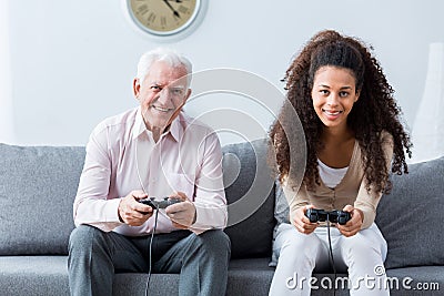 Holding joysticks and playing games Stock Photo