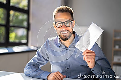 Holding Paycheck Or Payroll Check Or Insurance Cheque Stock Photo