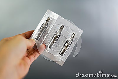 Holding tattoo needles. Stock Photo