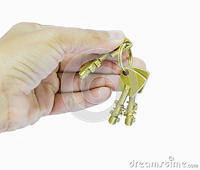 Holding three brass keys by hand Stock Photo