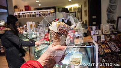 Holding traditional italian ice cream Gelato in the waffle cone in Venice Editorial Stock Photo