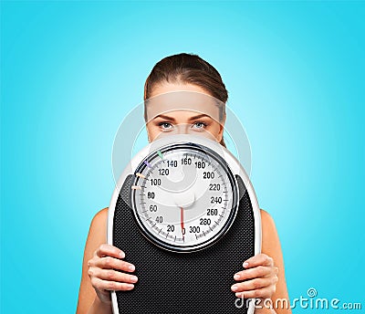 Beautiful young s woman holding scales Stock Photo