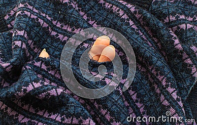 A hole in clothing made of wool. Concept of defect, marriage or insect moth Stock Photo