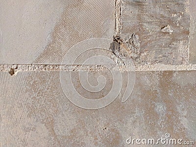 Hole crack in a wall made of stone rock bricks in beige color, damaged wallpaper background on a building Stock Photo