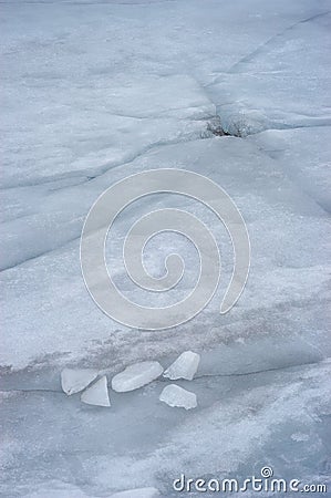 Hole and cracks and five ice blocks Stock Photo