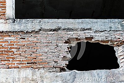 Hole in wall with broken tiles Stock Photo