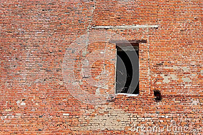 hole where a door should have been in the old brick wall of a crumbling industrial building Stock Photo