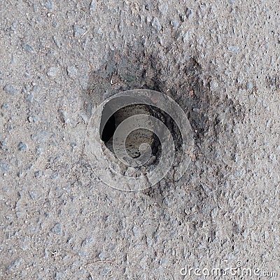 holes in the road for drains Stock Photo