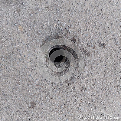 holes in the road for drains Stock Photo