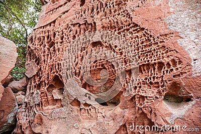 Holes in stone - Tafoni weathering in red sandstone Stock Photo