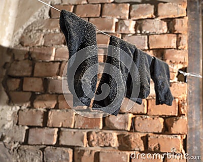 Holey old socks hanging on a rope Stock Photo