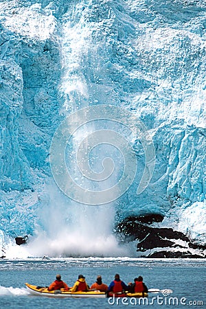 Holgate Glacier calving as kayakers watch in Alaska at Kenai Editorial Stock Photo