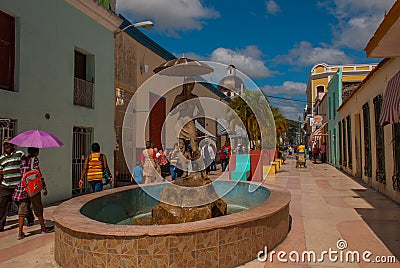 Holguin, Cuba: Central street with a statue of a girl with an umbrella with people and tourists. Editorial Stock Photo