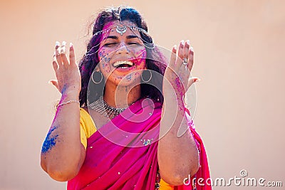 Holi Festival Of Colours. Portrait of happy indian girl in traditional hindu sari on holi color . india woman silver Stock Photo