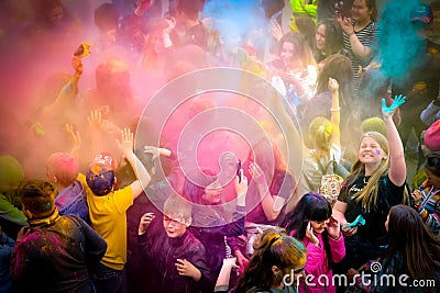 Holi Indian holiday. Young people in the crowd throw colored powders up and have fun Editorial Stock Photo