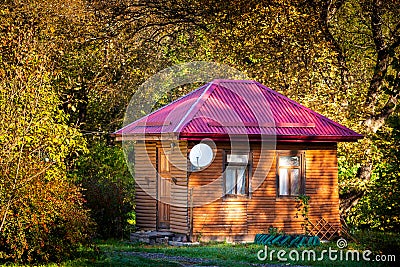 Holiday apartment - wooden cottage house in forest in early autumn Stock Photo