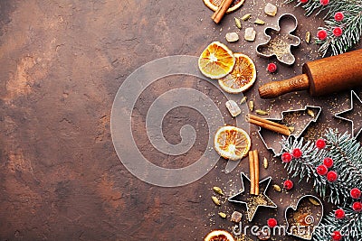 Holiday christmas background for baking cookies with cutters, rolling pin and spices on brown table top view. Copy space for text. Stock Photo