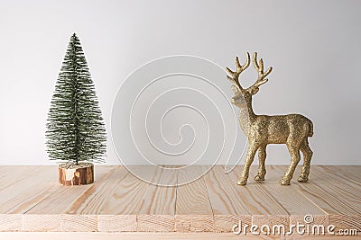 Holiday concept with reindeer and Christmas tree on wooden table. Creative Christmas or New Year background Stock Photo