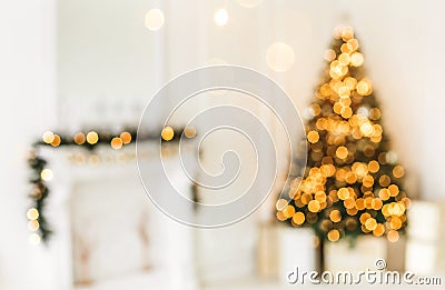 Holiday decorated room with Christmas tree and decoration, background with blurred, sparking, glowing light. Stock Photo