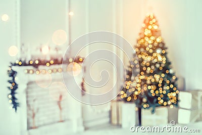 Holiday decorated room with Christmas tree and decoration, background with blurred, sparking, glowing light. Stock Photo