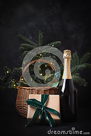 Holiday gift hamper with craft gift and sparkline wine on black. Christmas present. Stock Photo