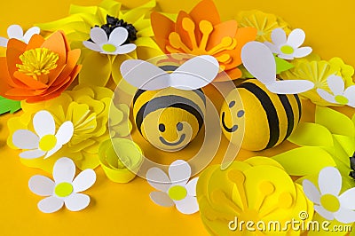 Holiday honey. Yellow background. Handicraft bee painted egg. Easter. Origami paper flower. Lettering Stock Photo