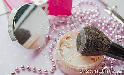 Friable powder and brush on the background of a mirror Stock Photo