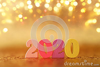 Holiday image of New Year 2020 concept. Wooden number and sparkling background Stock Photo