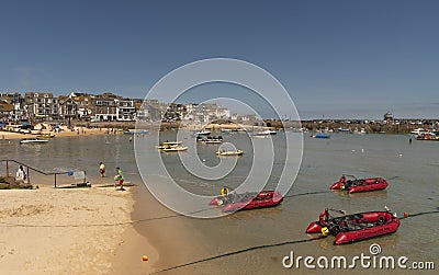 Holiday resort with red dinghies for rent. St Ives, UK Editorial Stock Photo