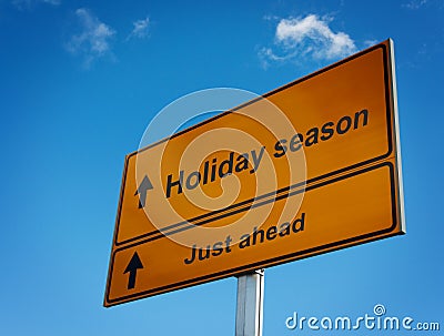 Holiday season road sign background sky. Stock Photo