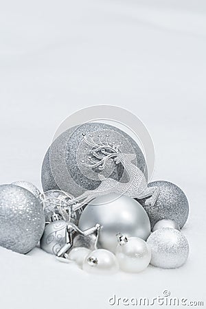 Holiday silver decorative Christmas baubles and star with Santa Claus's reindeer at natural snow background Stock Photo