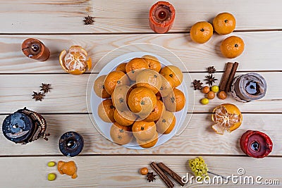 Holiday tangerines lie on wooden table. Stock Photo