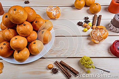 Holiday tangerines lie on wooden table. Stock Photo