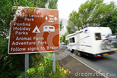 Holiday traffic passing tourist sign Editorial Stock Photo