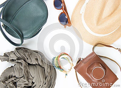 Holiday, travel background. Green cross bag, straw hat, retro brown sunglasses, grey scarf, retro camera, bocho bracelet Stock Photo