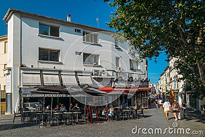 Holidaymakers in Antibes, Cote d`Azur, France sit at a terrace in a restaurant during the summer Editorial Stock Photo