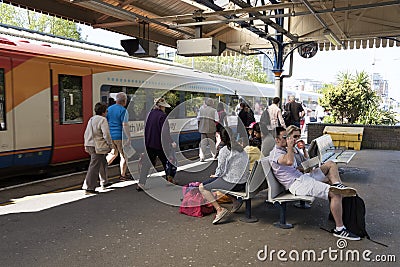 Passenger train and passengers on the train station platform Editorial Stock Photo