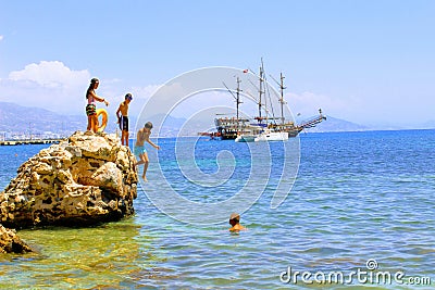 Holidaymakers sunbathe on a huge rock in the sea Alanya, Turkey Editorial Stock Photo