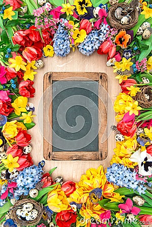 Holidays background chalkboard. Spring flowers easter eggs Stock Photo